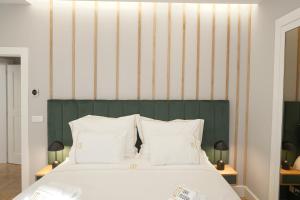 a bed with a green and white striped wall at Torre Medieval in Viseu