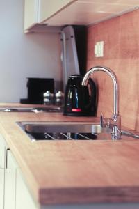 a kitchen sink with a black tea kettle on it at SIBL LOFTS in Thessaloniki