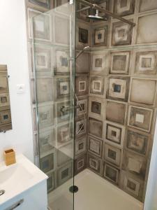 a shower with a glass door in a bathroom at Le New York de Marchaux 2 in Marchaux