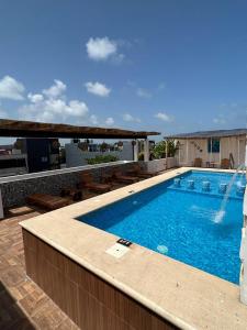 a swimming pool on the side of a building at Hotel Ko'ox Wenne in Tulum