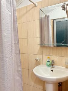 a bathroom with a sink and a mirror at Mussels apartments in Ksamil +20 photos