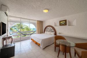 a hotel room with a bed and a table at Hotel Maya Caribe Faranda Cancún in Cancún