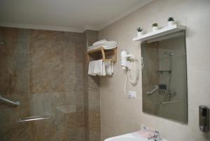 a bathroom with a shower and a sink and a mirror at El ParaÍso de Guriezo in Pomar +43 photos