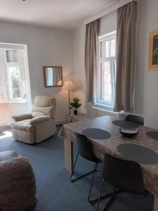 a living room with a table and a couch at Apartment Descamps in Blankenberge