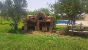 a small structure in the grass next to a pool at Gîte avec piscine privé in Agadir