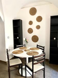 a dining room with a white table and chairs at La bodeguita 1 in Zafra