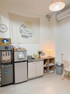 a kitchen with a sink and a counter top at HoHo Woo Tainan Homestay in Tainan