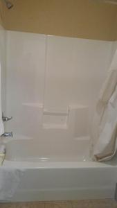 a white bath tub in a bathroom with a white wall at Murphy Motel in Letitia