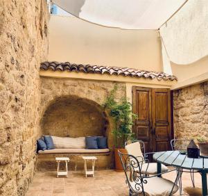 a patio with a bench in a stone wall at Araçatı Pansiyon in Cesme