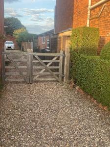 a wooden gate in front of a house at The Coach House By The Sea in Mablethorpe