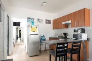 a kitchen with a stainless steel refrigerator and cabinets at New Ampartment For Rent in Jarretadera