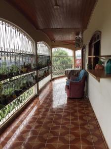 a balcony with a couch and some plants at Hostel Roraima in Boa Vista