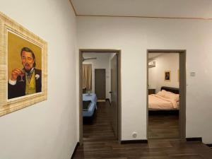 a room with a painting of a man at Homestay Balik Pulau in Balik Pulau