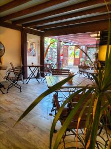 a restaurant with tables and chairs and a potted plant at Hotel Mary's House in Selçuk