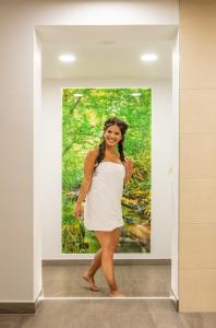 a woman in a white dress standing in a painting at Gemünder Ferienpark Salzberg in Schleiden