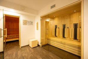 a dressing room with wooden cabinets and a mirror at Gemünder Ferienpark Salzberg in Schleiden