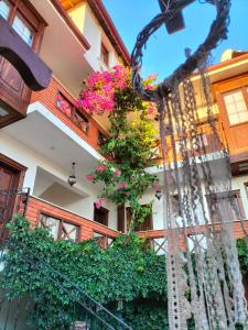 a building with flowers on a balcony at Hotel Mary's House in Selçuk