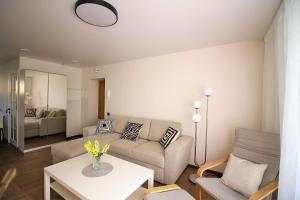 a living room with a couch and a table at BAM apartments in Palanga