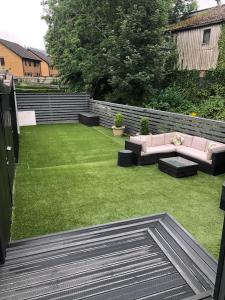 a backyard with a pink couch and a lawn at Glan Aber 1890, snowdonia, Llanrwst in Llanrwst