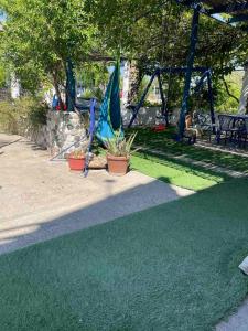 a park with a swing set and a playground at Gennadi Beach Apartments in Gennadi