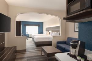 a hotel room with a bed and a large mirror at Holiday Inn Express & Suites Denver Airport by IHG in Denver +55 photos