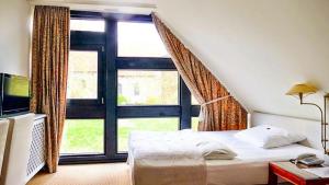 Postel nebo postele na pokoji v ubytování Meyers Hotel Hittfeld