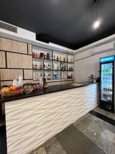 a bar in a restaurant with a drink refrigerator at Olive hotel in Yerevan