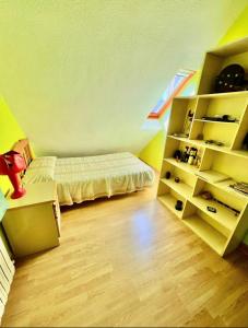 a small room with a bed and a book shelf at Palau de Vic in Valencia