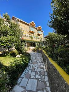a stone path in front of a building at House 1960 in Lin