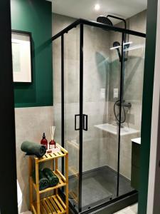 a shower with a glass door in a bathroom at Nowoczesny apartament w sercu Wrocławia in Wrocław