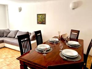 a dining room with a table and chairs and a couch at Apartment Sawetz - Ptuj in Ptuj