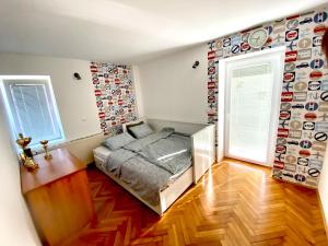 a bedroom with a bed and a wall of plates at Apartment Sawetz - Ptuj in Ptuj