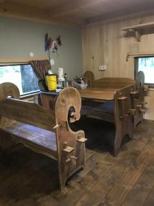 a dining room with a wooden table and chairs at Medže dirbtuve 