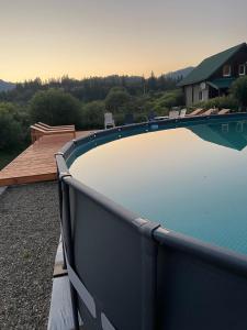 a large swimming pool sitting next to a house at Сонячні Карпати in Slavske