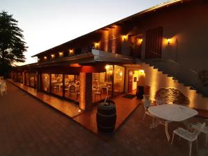 a building with tables and chairs on a patio at LA LOCANDA DELLA STAFFA in Pombia