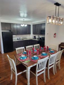 a dining room table with chairs and a kitchen at Reservoir Hill Mansion - 4 bedrooms in Baltimore