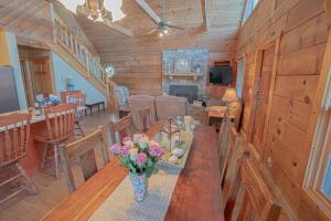 a dining room with a table with flowers on it at Poppy’s Place Cabin in Dandridge