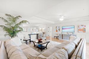 a living room with a couch and a table at Watercolor Townhouse 9 in Seagrove Beach