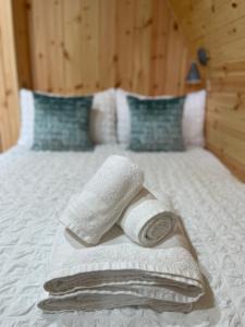 a bed with towels and pillows on it at Allt Yelkie Pod Aon, Earlish in Earlish