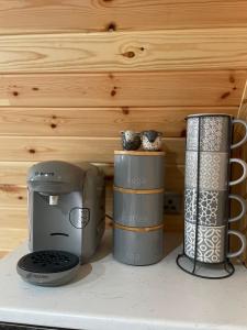 a kitchen counter with two coffeemakers on a shelf at Allt Yelkie Pod Aon, Earlish in Earlish