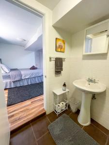a bathroom with a sink and a bed at Wrigley Garden Unit in Chicago