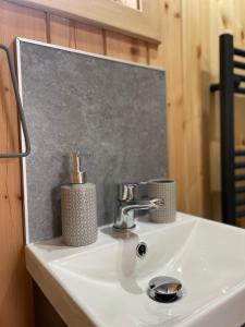 a white sink with two candles on top of it at Allt Yelkie Pod Aon, Earlish in Earlish