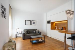 a living room with a couch and a table at Minimal Rooms by ELE Apartments in Málaga