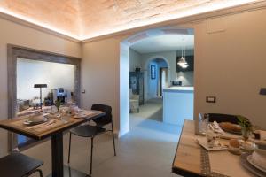 a dining room with a table and chairs and a kitchen at Anima di Vinci in Vinci
