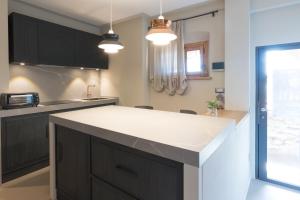 a kitchen with black cabinets and a white counter top at Anima di Vinci in Vinci