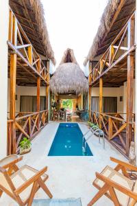 a villa with a swimming pool and a resort at Alma de Zorro in Bacalar