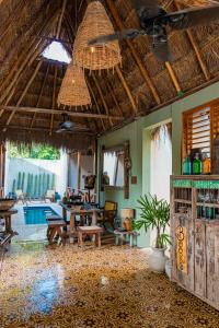 a room with a table and chairs and a ceiling at Alma de Zorro in Bacalar