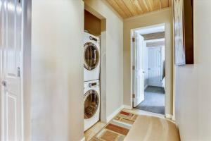 a laundry room with two washer and dryer at Downtown Aspen 2 Bedroom Condo in Aspen
