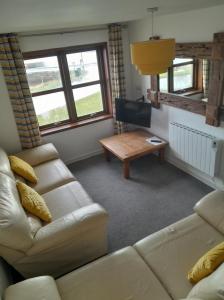 a living room with a couch and a table at 2 Harbour Row in Helmsdale