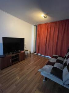 a living room with a flat screen tv and a couch at Orella 6p Apartament in Antofagasta